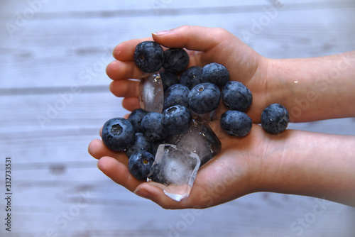 Ripe blueberries in children's hands