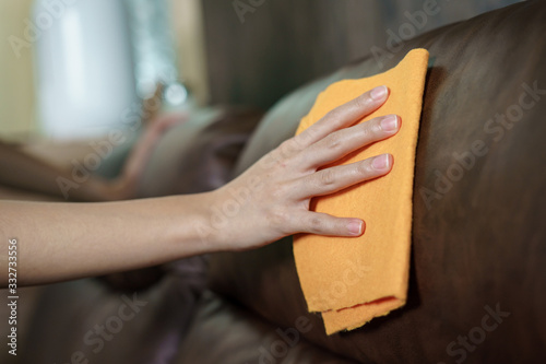 Women Hand cleaning sofa disinfectant for corona virus or Covid-19 protection.