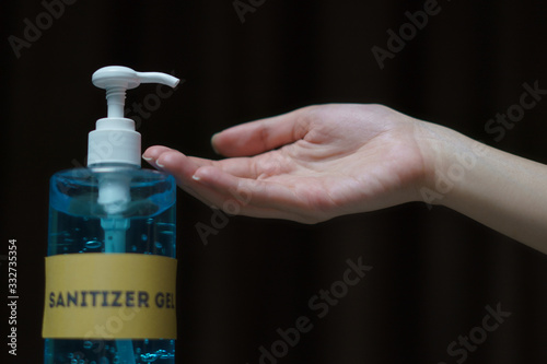 Woman washing hands with alcohol gel or sanitizer gel. corona virus or Covid-19 protection.