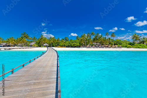 Beautiful tropical beach with white sand, palm trees, turquoise ocean against blue sky with clouds on sunny summer day. Perfect landscape background for relaxing travel vacation, island of Maldives