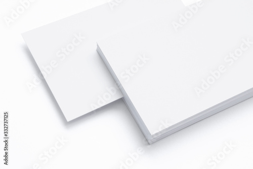 Close view of blank business cards isolated on white as template for logo, embossing design presentation, promotion etc.