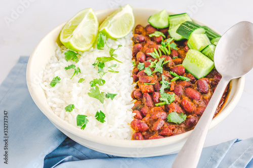 Indian Rajma Chawal in a Bowl on White Background with Lemon, Cucumber and Onion Close Up Horizontal Stock Photo
