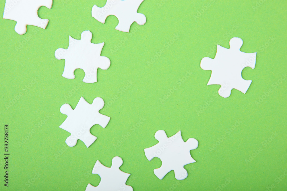 White puzzle on a colored background top view.