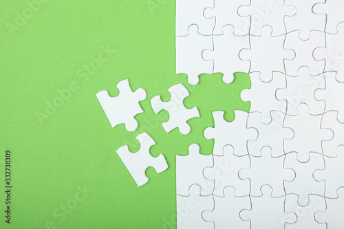 White puzzle on a colored background top view. © White bear studio 