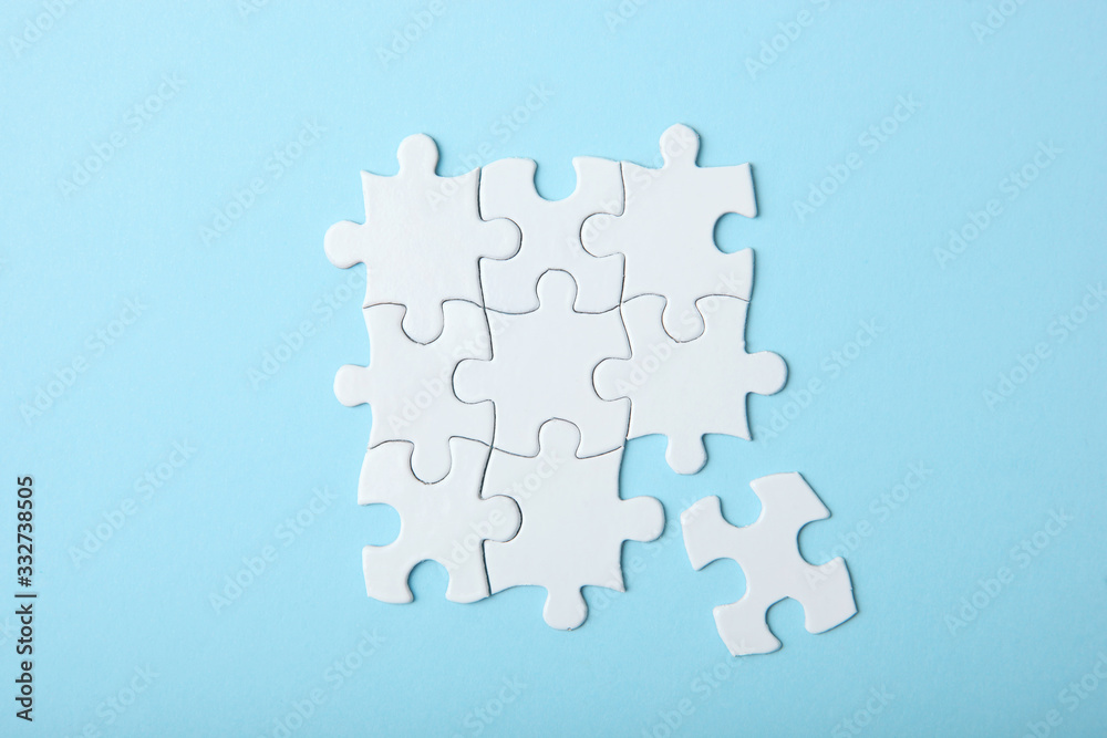 White puzzle on a colored background top view. White puzzle on a colored background top view.