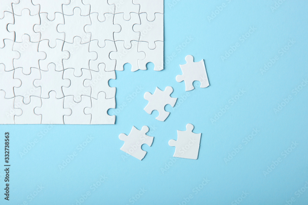 White puzzle on a colored background top view. White puzzle on a colored background top view.
