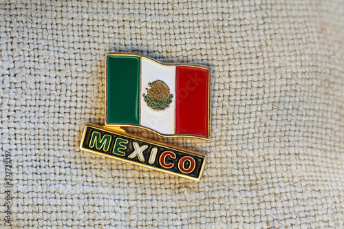 Metal badge with mexican flag and word  MEXICO photo