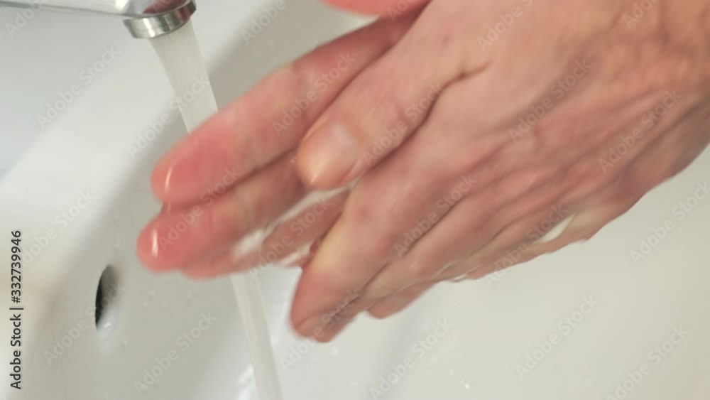 Washing hands in the bathroom sink to prevent spreading the coronovirus covid-19. Hygiene is an important prevention method to stop the virus from spreading. Washing hands in the bathroom sink to prevent spreading the coronovirus covid-19. Hygiene is an important prevention method to stop the virus from spreading.