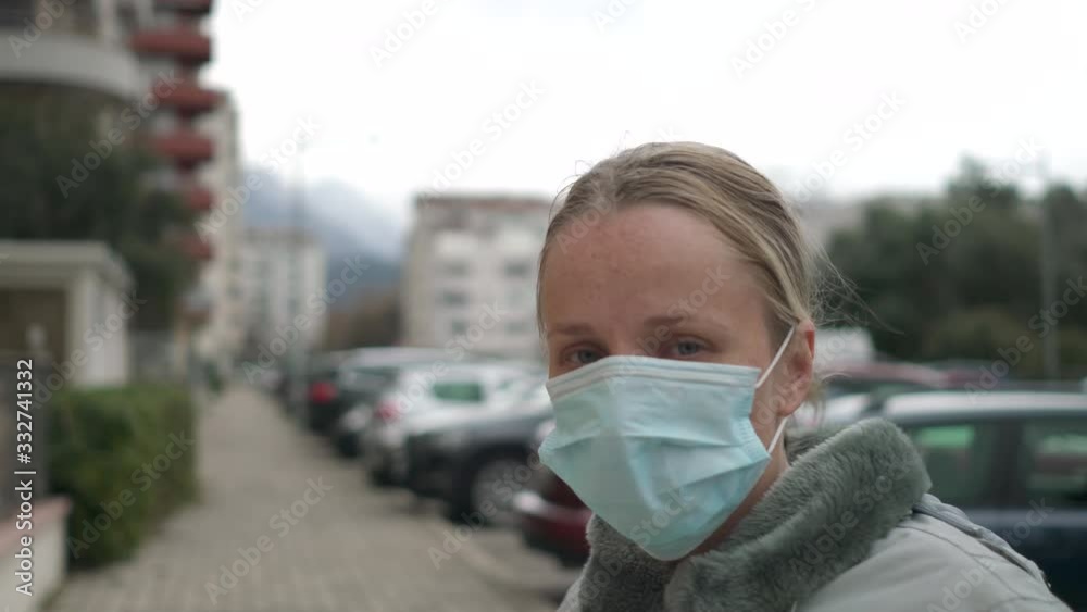 woman putting on surgical mask for corona virus prevention. woman putting on surgical mask for corona virus prevention.