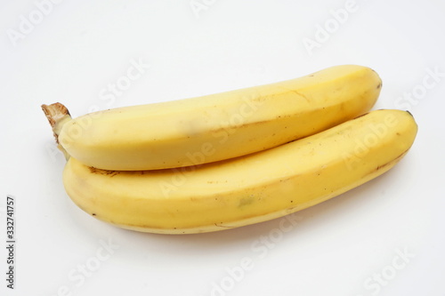 Ripe, yellow bananas isolated on a light background