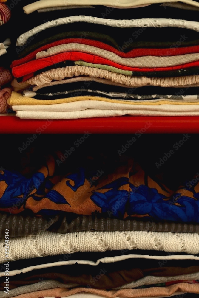 Colorful clothes folded in a closet. Selective focus. Colorful clothes folded in a closet. Selective focus.