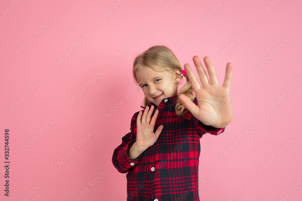 Rejecting, stop it. Caucasian little girl's portrait on pink studio background. Beautiful female model with blonde hair. Concept of human emotions, facial expression, sales, ad, youth, childhood. Rejecting, stop it. Caucasian little girl's portrait on pink studio background. Beautiful female model with blonde hair. Concept of human emotions, facial expression, sales, ad, youth, childhood.