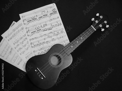 Music notes and ukulele . Concept of Music lovers. Black and white photo