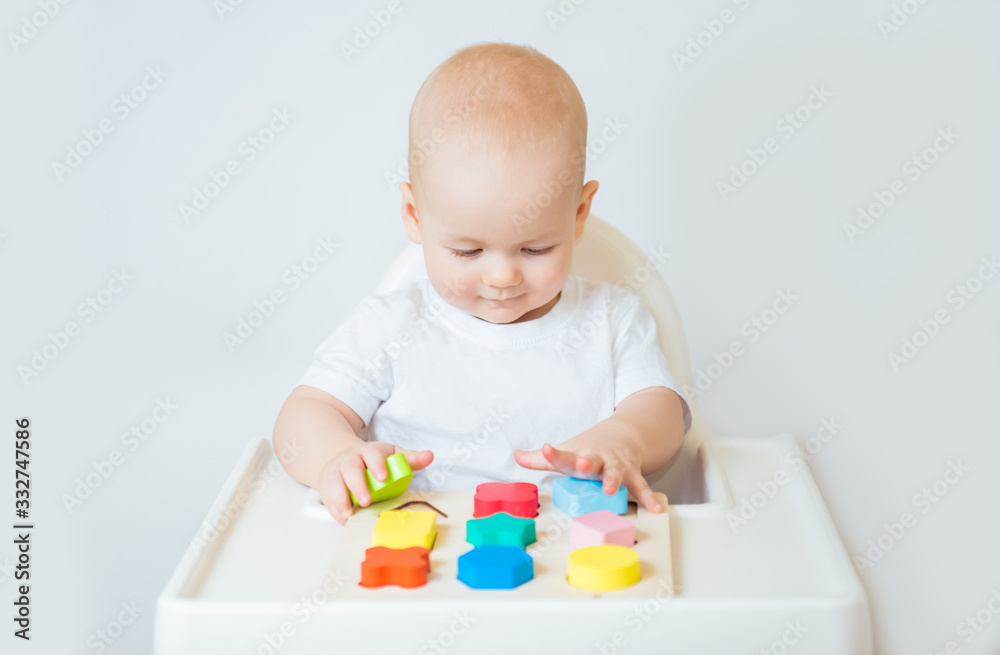 Child little boy playing wooden toys at home or kindergarten Child little boy playing wooden toys at home or kindergarten