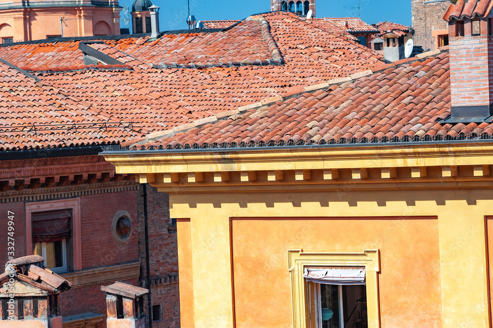 Chimney pipe and old ceramic shingles tile on the roof.