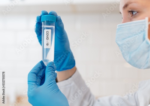Female Scientist Medical Research Lab researching test tubes virus covid - 19 in laboratory