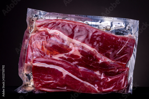 Bright red prepared vacuum packed preservable Jerked Beef [Dianteiro] as found in Brazilian supermarket with reflective aluminium packaging photo