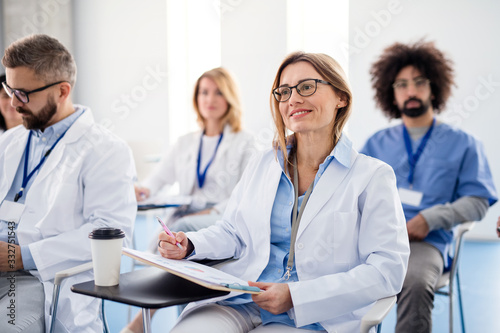 Group of doctors on conference, medical team sitting and listening.