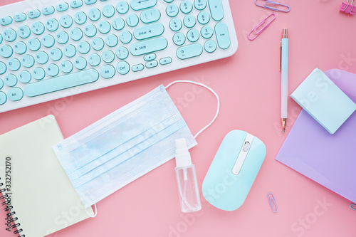 modern workplace with medical mask and spray with a disinfectant. New hygiene rules in connection with coronavirus..