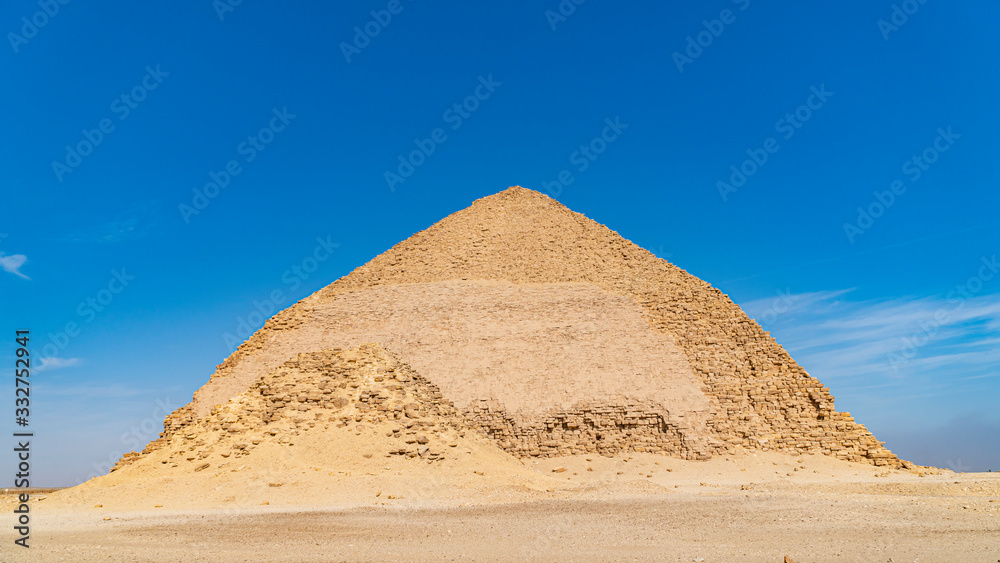 The Bent Pyramid is an ancient Egyptian pyramid located at the royal necropolis of Dahshur, approximately 40 kilometres south of Cairo, built under the Old Kingdom Pharaoh Sneferu. Egypt The Bent Pyramid is an ancient Egyptian pyramid located at the royal necropolis of Dahshur, approximately 40 kilometres south of Cairo, built under the Old Kingdom Pharaoh Sneferu. Egypt