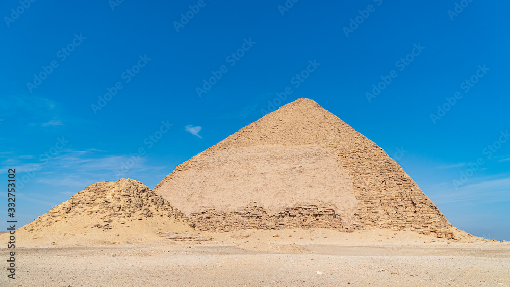 The Bent Pyramid is an ancient Egyptian pyramid located at the royal necropolis of Dahshur, approximately 40 kilometres south of Cairo, built under the Old Kingdom Pharaoh Sneferu. Egypt The Bent Pyramid is an ancient Egyptian pyramid located at the royal necropolis of Dahshur, approximately 40 kilometres south of Cairo, built under the Old Kingdom Pharaoh Sneferu. Egypt
