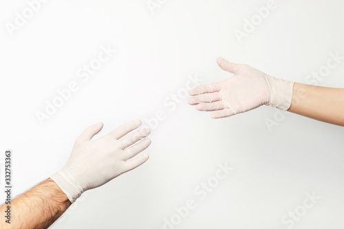 No matter what - we are together. Male and female hand in medical gloves holding each other. © Aleksandra Abramova