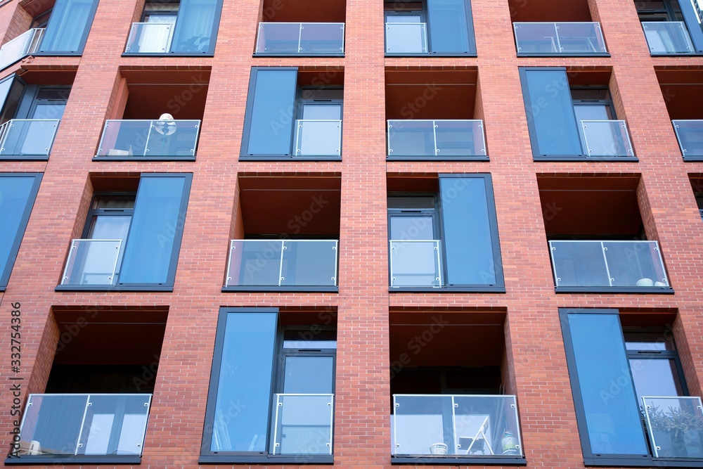Exterior of new apartment buildings on a blue cloudy sky background. No people. Real estate business concept. Exterior of new apartment buildings on a blue cloudy sky background. No people. Real estate business concept.