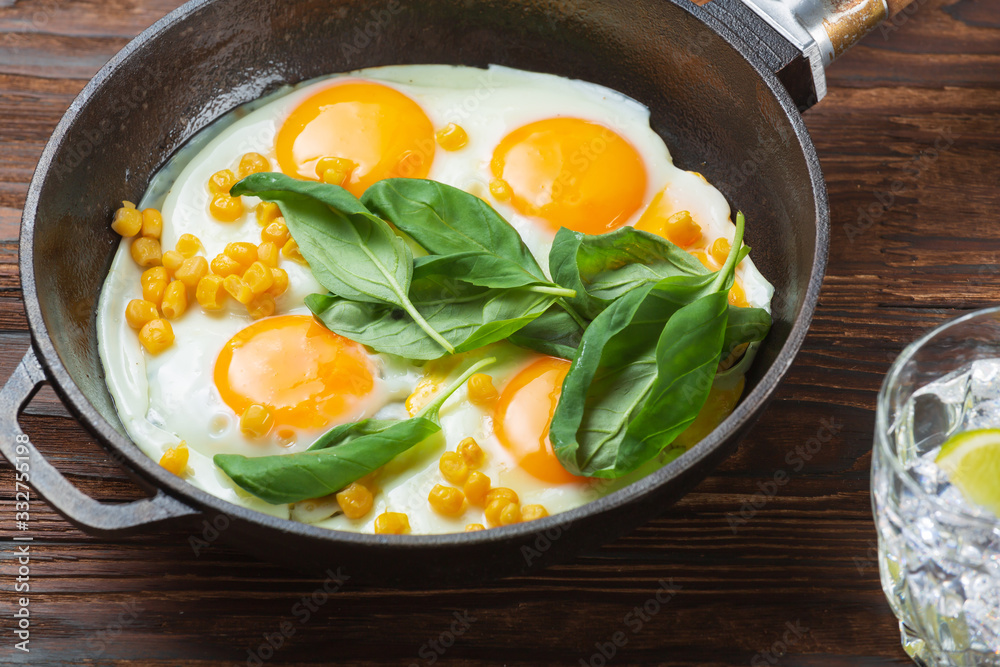 Fried eggs for breakfast close-up. Wooden table. Healthy eating