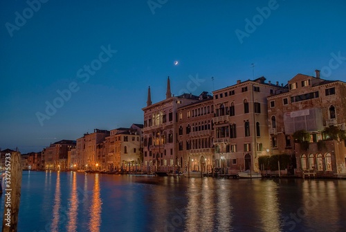 The moon in a clear night sky over the Grand Canal in Venice, Italy