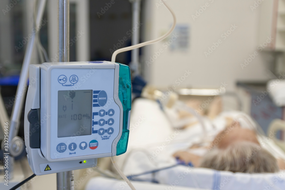 © patrikslezak - A small, lightweight, portable enteral feeding pump in ICU in hospital, on background patient in bed connected to medical ventilator in ICU in hospital © patrikslezak - A small, lightweight, portable enteral feeding pump in ICU in hospital, on background patient in bed connected to medical ventilator in ICU in hospital