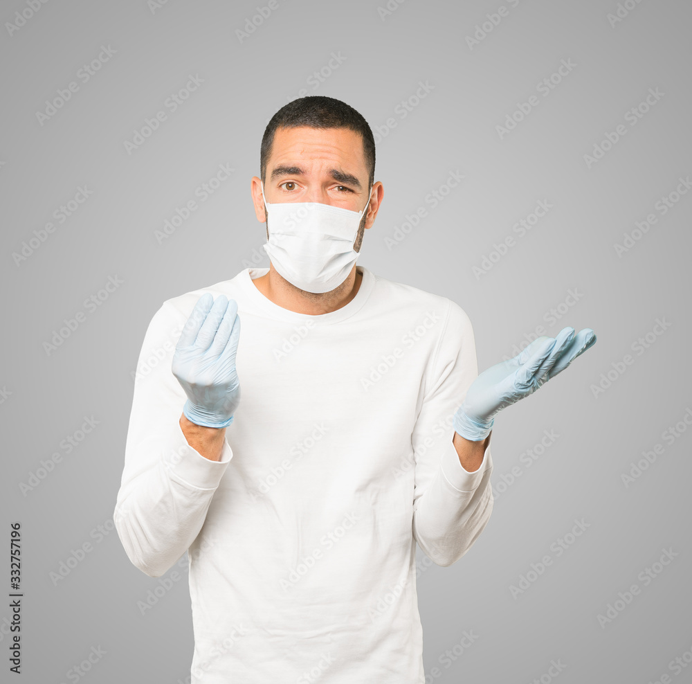 Coronavirus.Young man doing concepts and wearing mask and protective gloves Coronavirus.Young man doing concepts and wearing mask and protective gloves