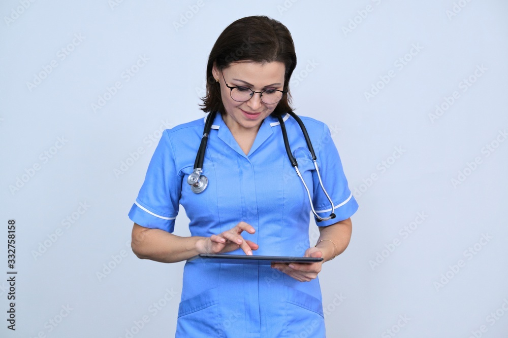 Middle-aged female medical worker with digital tablet Middle-aged female medical worker with digital tablet