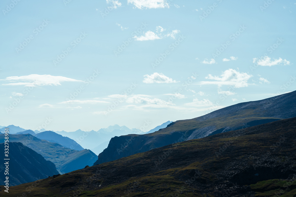 Awesome scenic view to great mountains in distance behind deep gorge. Wonderful mountain landscape with giant rockies and deep abyss. Highland scenery with huge cliff. Big rocks and precipice.