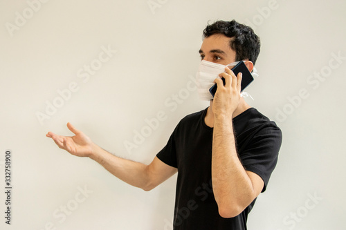 Man wearing protection face against coronavirus and using mobile smartphone. Medical surgical mask. Novel coronavirus. (2019-nCoV). Covid-19. photo
