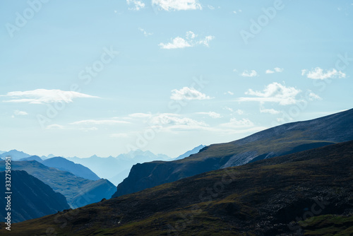 Fototapeta Naklejka Na Ścianę i Meble -  Awesome scenic view to great mountains in distance behind deep gorge. Wonderful mountain landscape with giant rockies and deep abyss. Highland scenery with huge cliff. Big rocks and precipice.