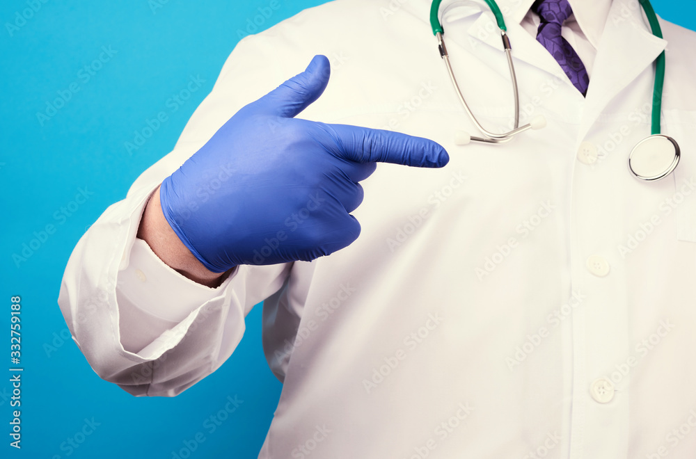 medic man in white coat with buttons, on hands wearing blue sterile gloves medic man in white coat with buttons, on hands wearing blue sterile gloves