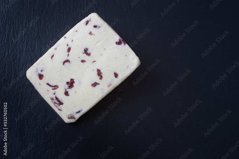 A slice of British Wensleydale and Cranberry cheese A slice of British Wensleydale and Cranberry cheese