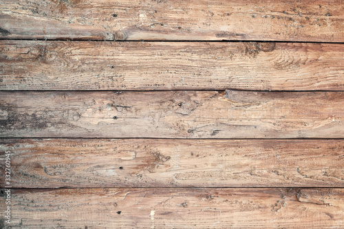 Backgroud of aged rounded natural wood fence texture. Horizontal arrangement of boards