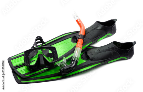 Mask, red snorkel and flippers of light green color with water drops