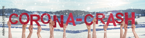 People Hands Holding Colorful English Word Corona-Crash. Snowy Winter Background With Snowflakes