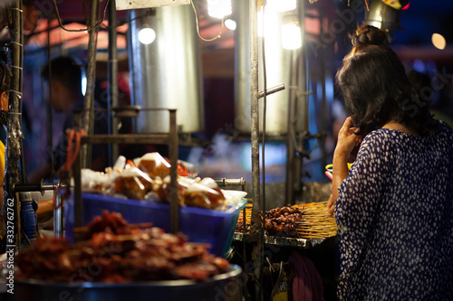 KHONKAEN, TH - March 25, 2020: People are buying chicken grilled at "talad torung" night market.