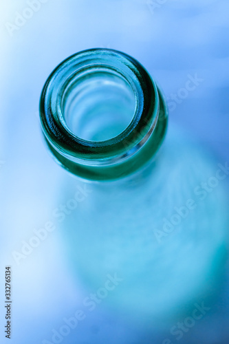 the neck of a blue glass bottle. Conceptual background. containers for alcoholic beverages