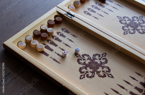 Fotografia, Obraz backgammona game of backgammon made of wood lies on a table