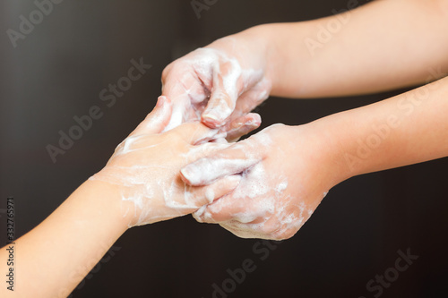 Front view on womans hands with soap foam, personal hygiene concept