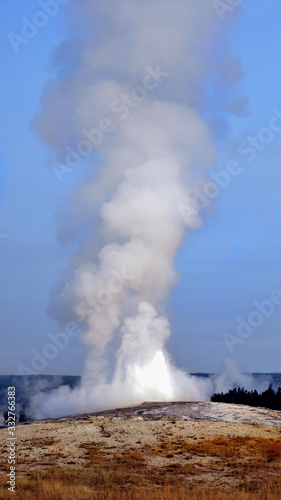 Old Faithful geyser eruption in Yellowstone National Park USA