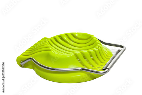 Fotografie Green egg slicer isolated on white background