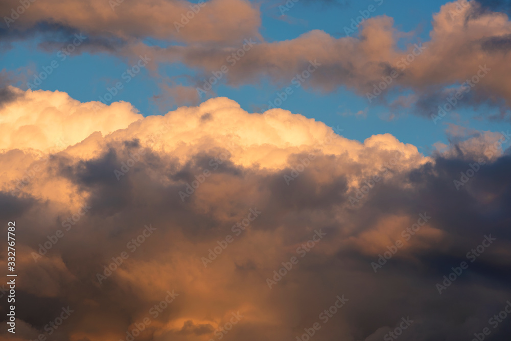 Orange clouds and sky background at golden hour time. Sunset