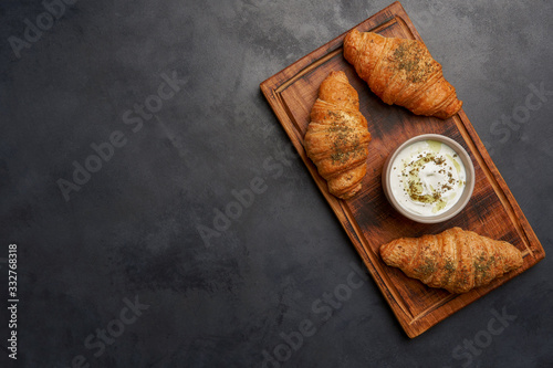 Croissants with zaatar  and labaneh on wooden board  photo