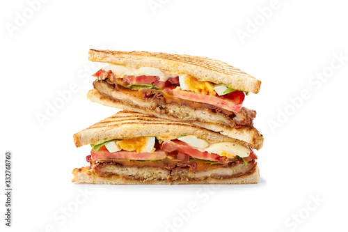 Two slices of juicy club sandwich on white