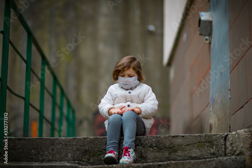 little girl on a walk in a medical mask © khanfus
